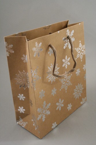 Natural Brown Kraft Paper Gift Bag with Silver Foil Snowflake Print and Brown Corded Handles. Size Approx 21cm x 18cm x 8cm.