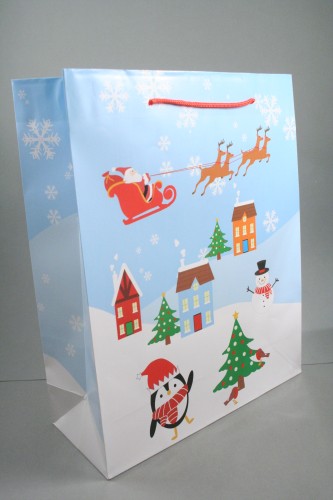 Christmas Scene Glossy Gift Bag with Blue Background and Red Cord Handles. Approx Size 32cm x 26cm x 10cm